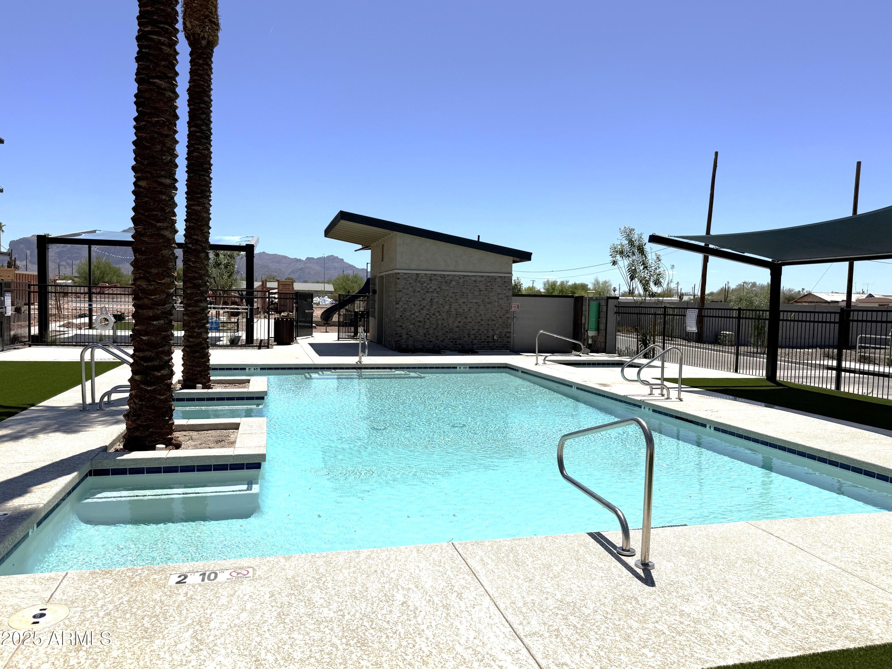 651 North Ironwood Drive, Unit 3 Apache Junction, AZ 85120 - Photo 41 of 48 a swimming pool with lawn chairs