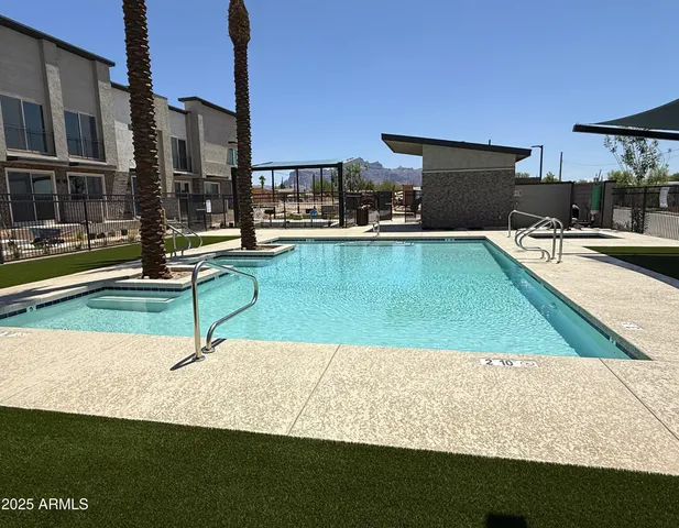 a view of a swimming pool with an outdoor seating