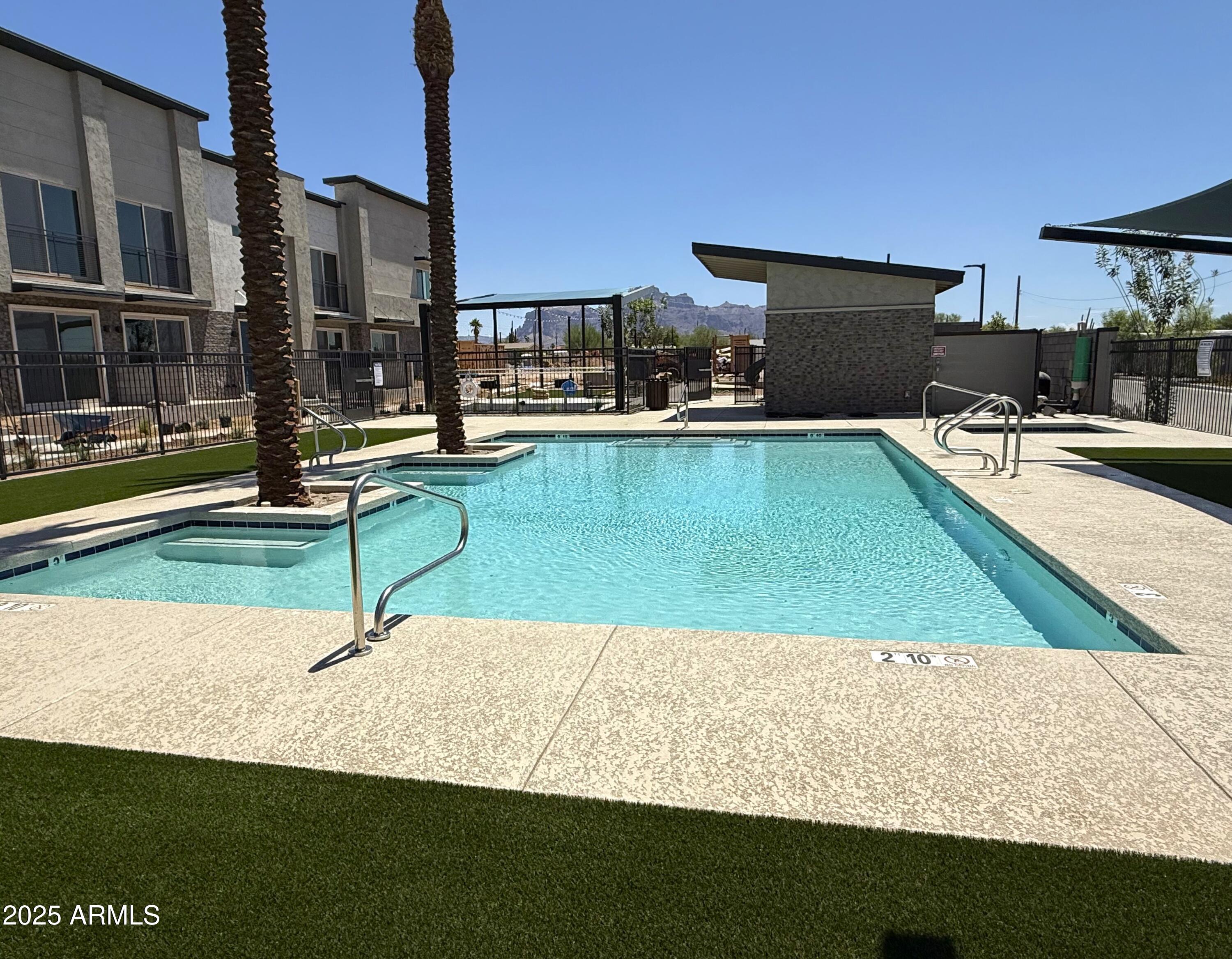 651 North Ironwood Drive, Unit 3 Apache Junction, AZ 85120 - Photo 42 of 48 a view of a swimming pool with an outdoor seating