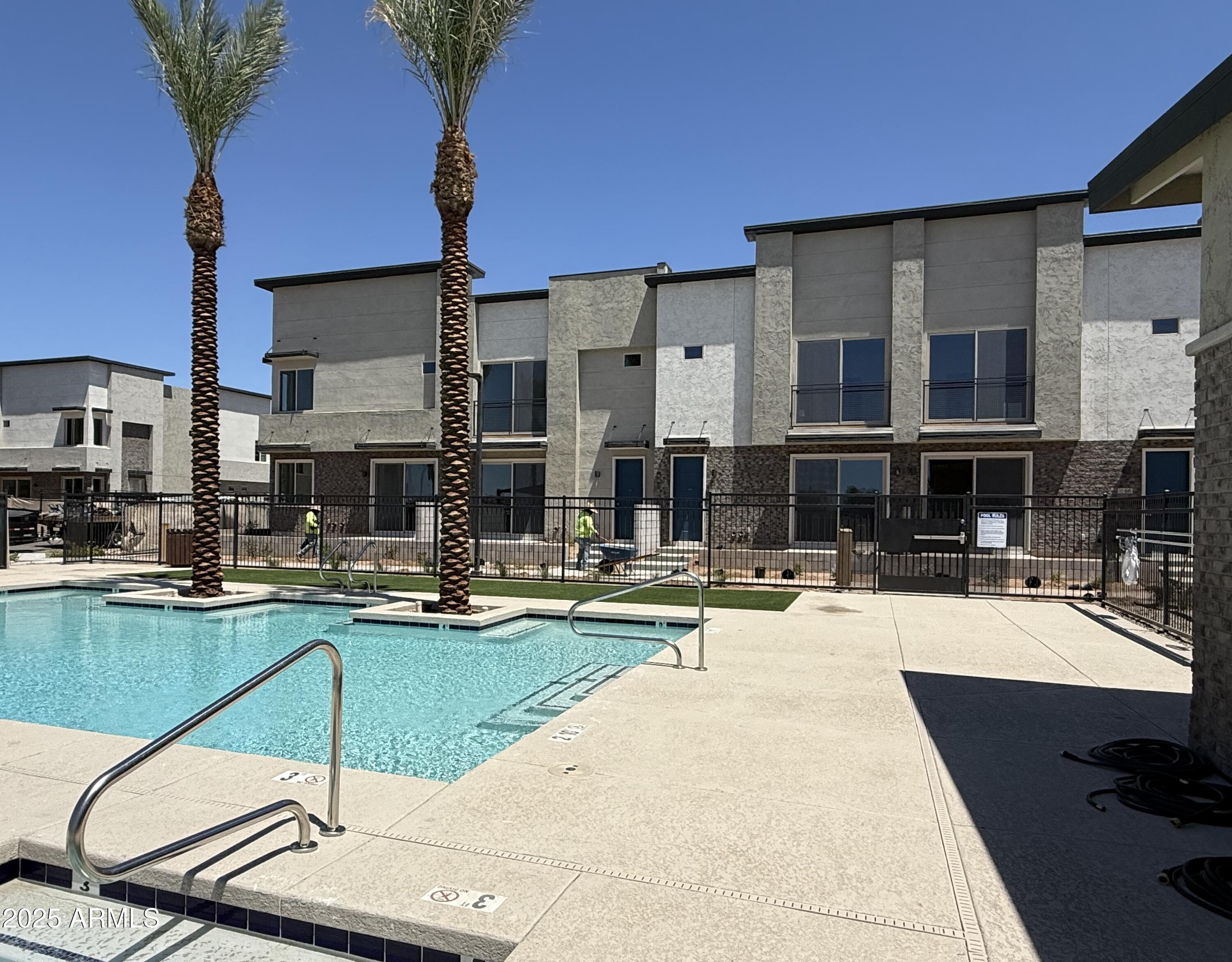 651 North Ironwood Drive, Unit 3 Apache Junction, AZ 85120 - Photo 45 of 48 a swimming pool with outdoor seating and yard