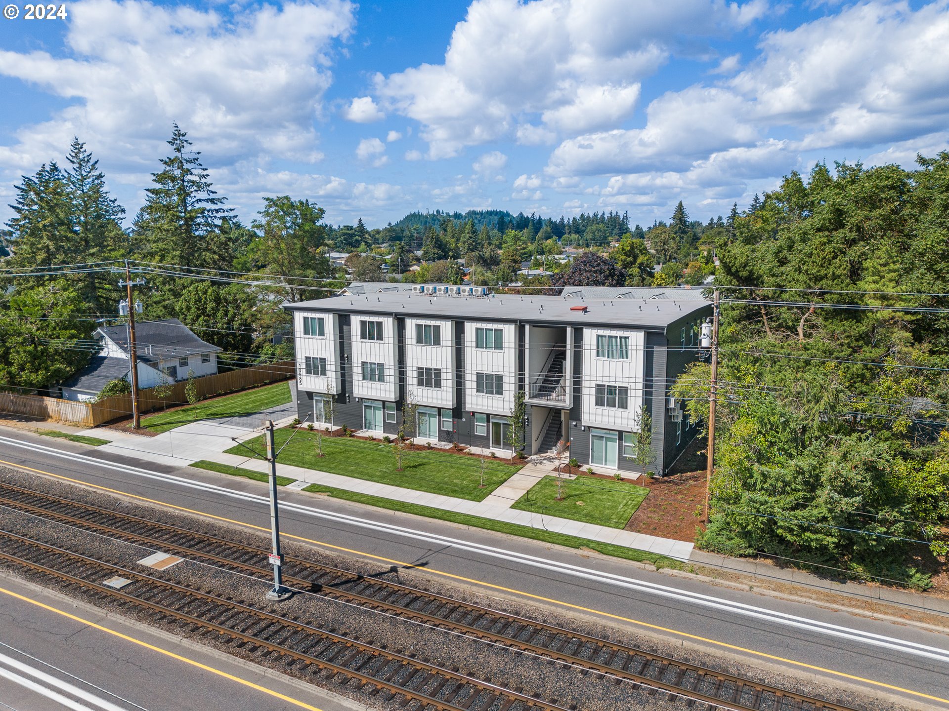 10985 East Burnside Street, Unit 1 Portland, OR 97216 - Photo 2 of 7 a view of a house with a yard