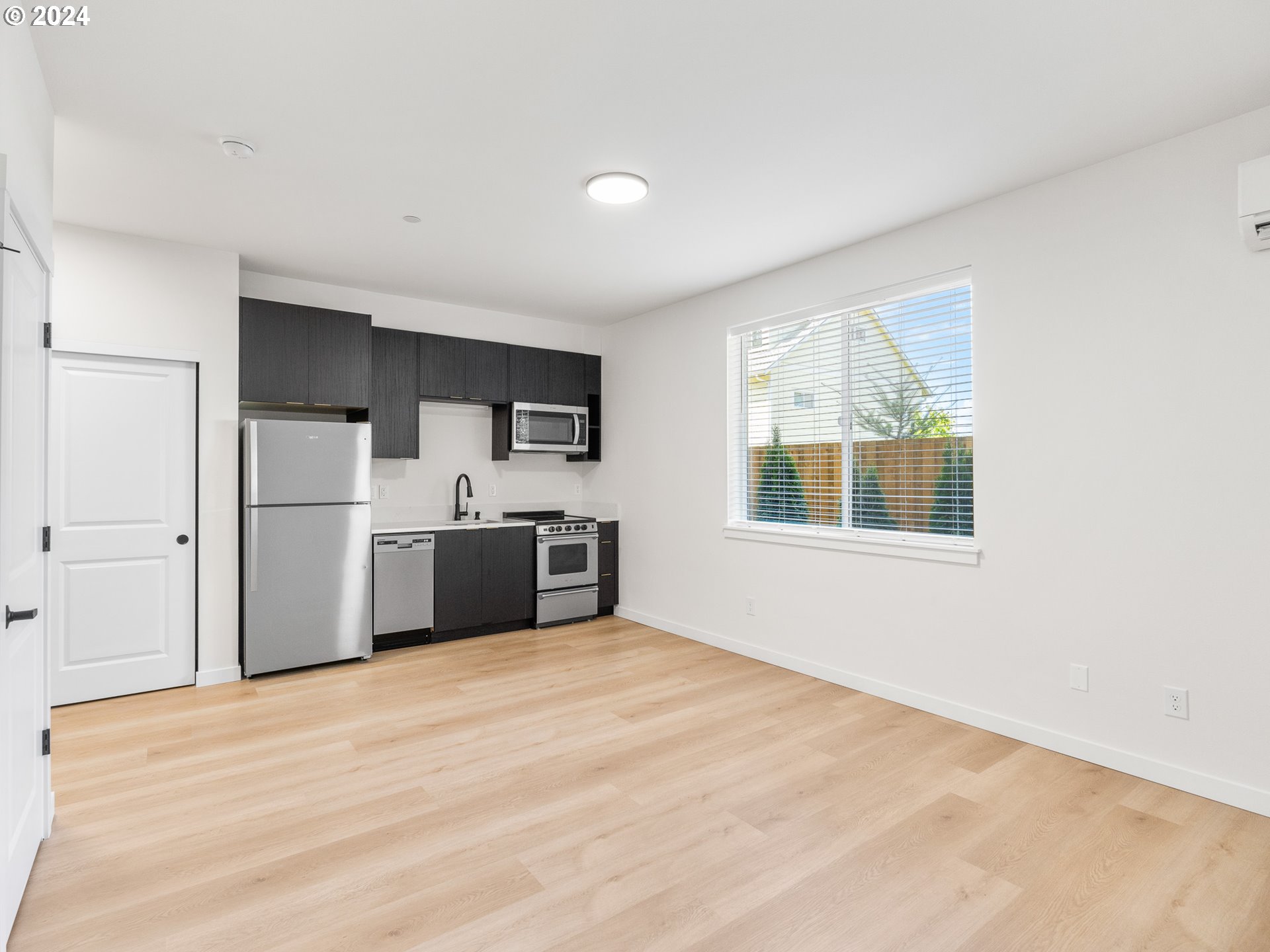 10985 East Burnside Street, Unit 1 Portland, OR 97216 - Photo 5 of 7 a view of a kitchen with microwave and cabinets