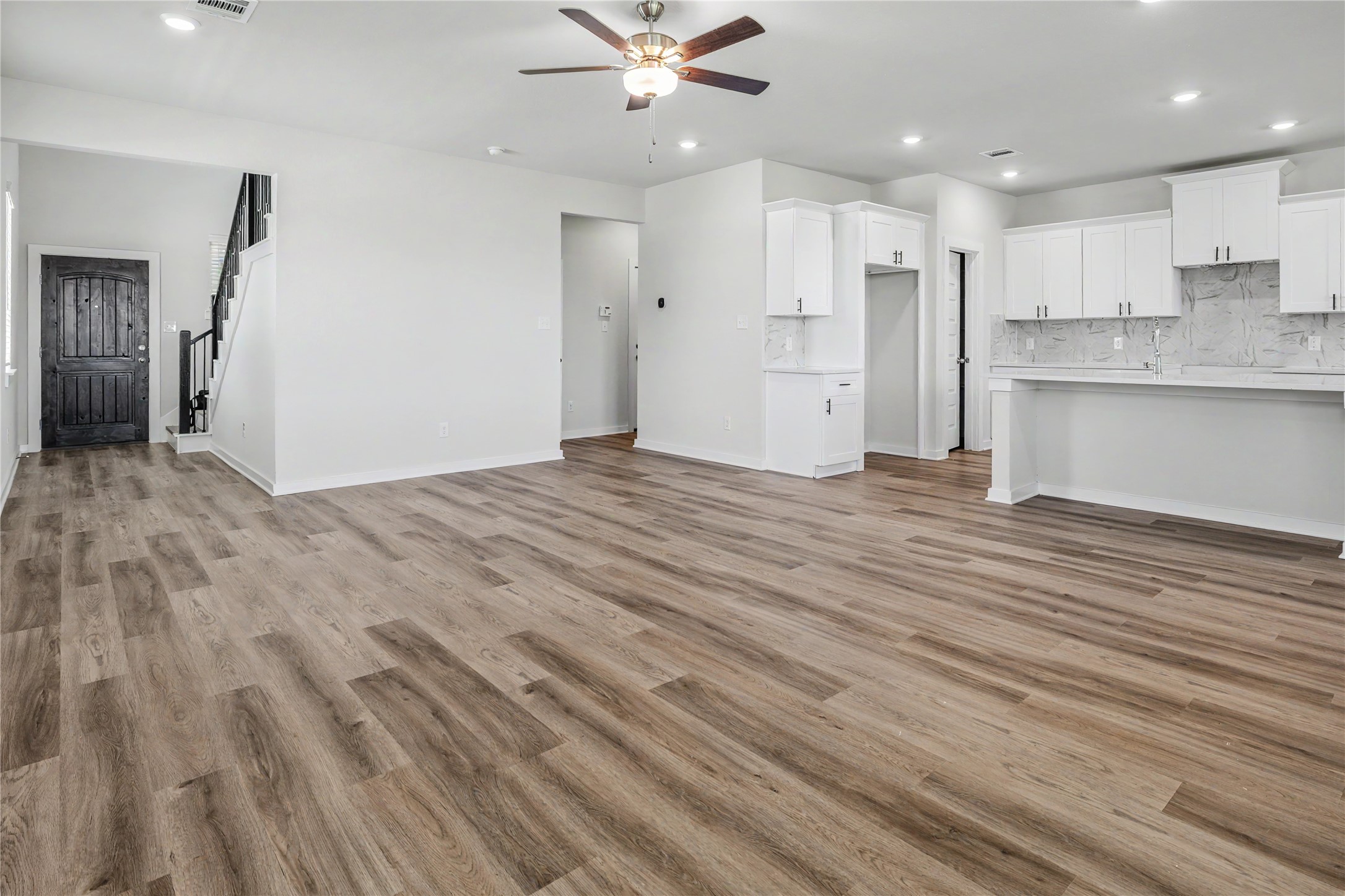 6427 Bolinas Court Rosharon, TX 77583 - Photo 9 of 49 a view of a kitchen with a sink and dishwasher a refrigerator with wooden floor