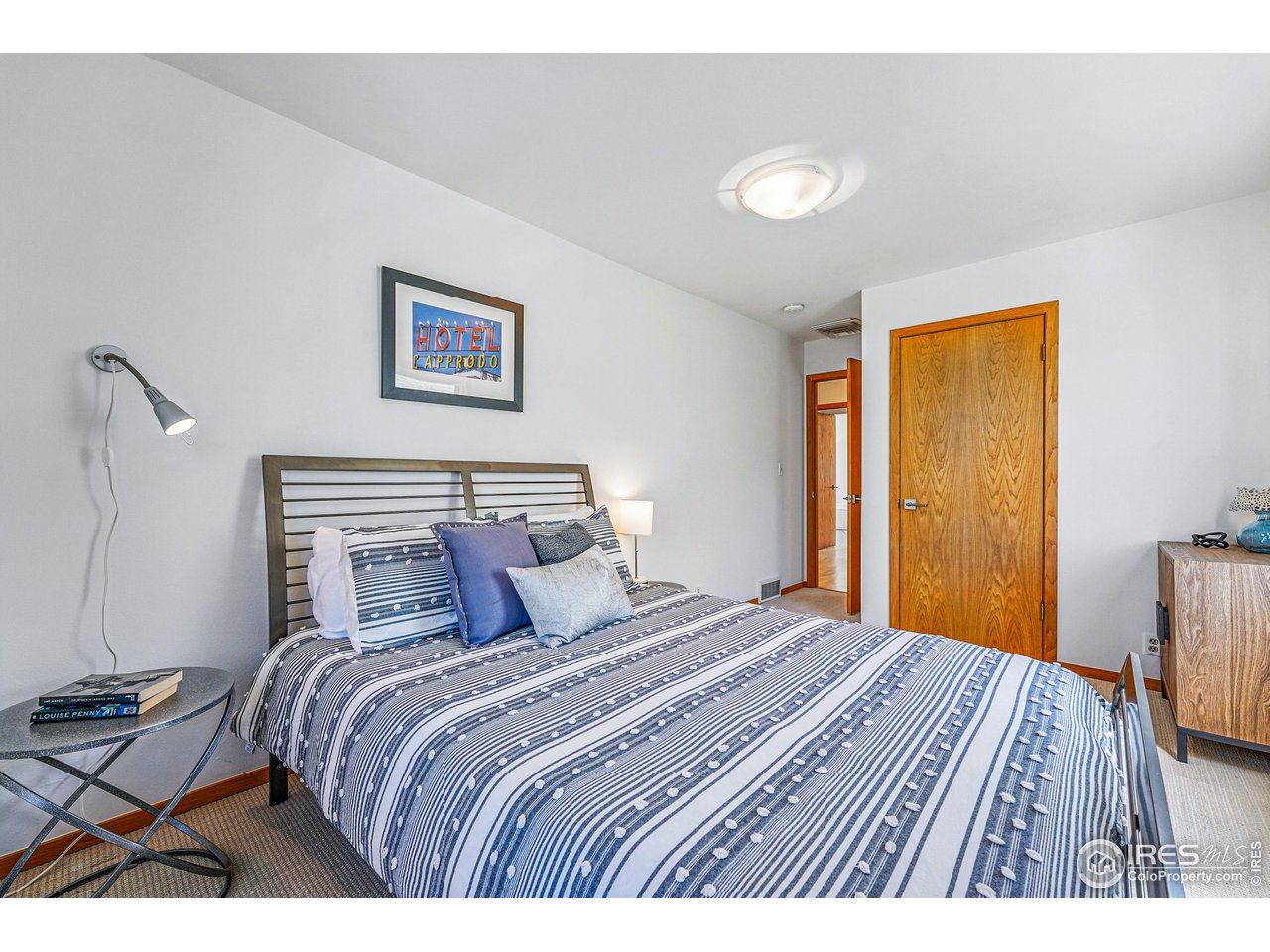 644 Dewey Avenue Boulder, CO 80304 - Photo 26 of 39 a bedroom with a bed and wooden floor