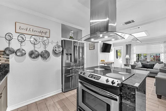a kitchen with a stove and a refrigerator