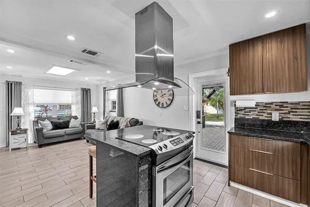 a kitchen with stainless steel appliances granite countertop a stove and a sink