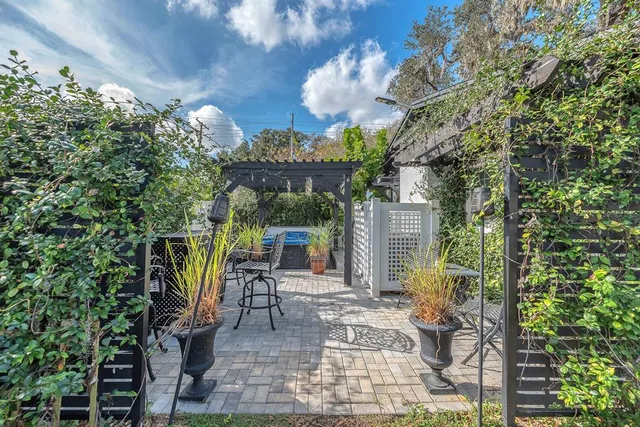 a view of a patio with table and chairs and potted plants