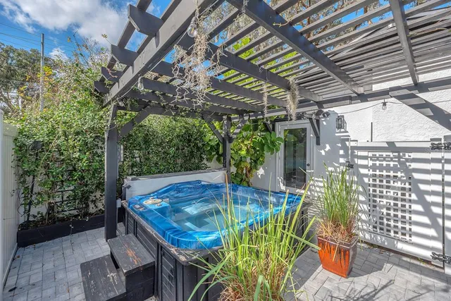 a view of a patio with table and chairs potted plants with wooden floor