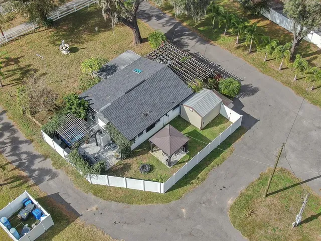 an aerial view of a house with a yard