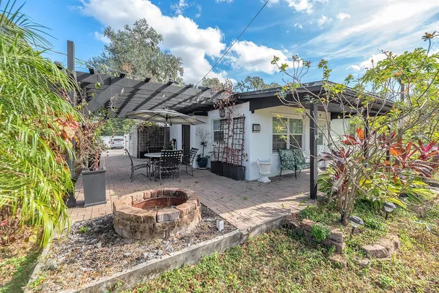 a view of a chair and table in backyard