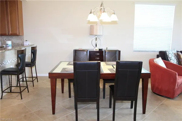 a view of a dining room with furniture and chandelier