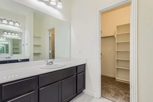 a bathroom with a double vanity sink and a mirror