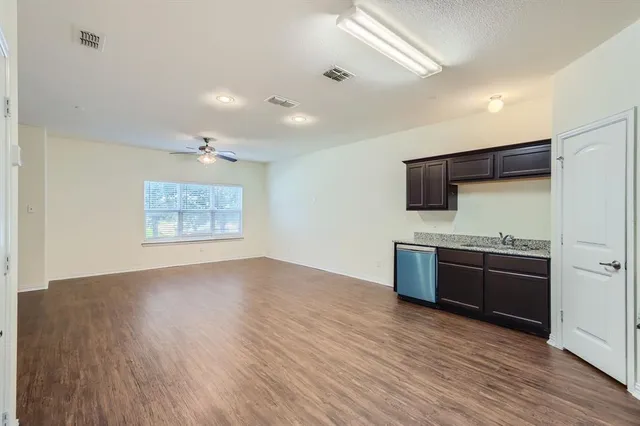 a view of kitchen with stainless steel appliances cabinets and wooden floor