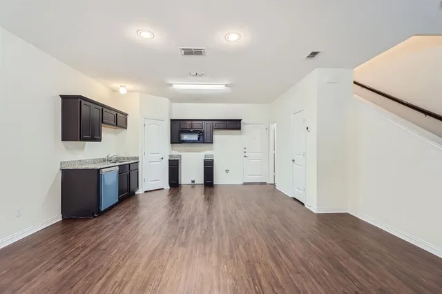 a view of kitchen with sink microwave and refrigerator
