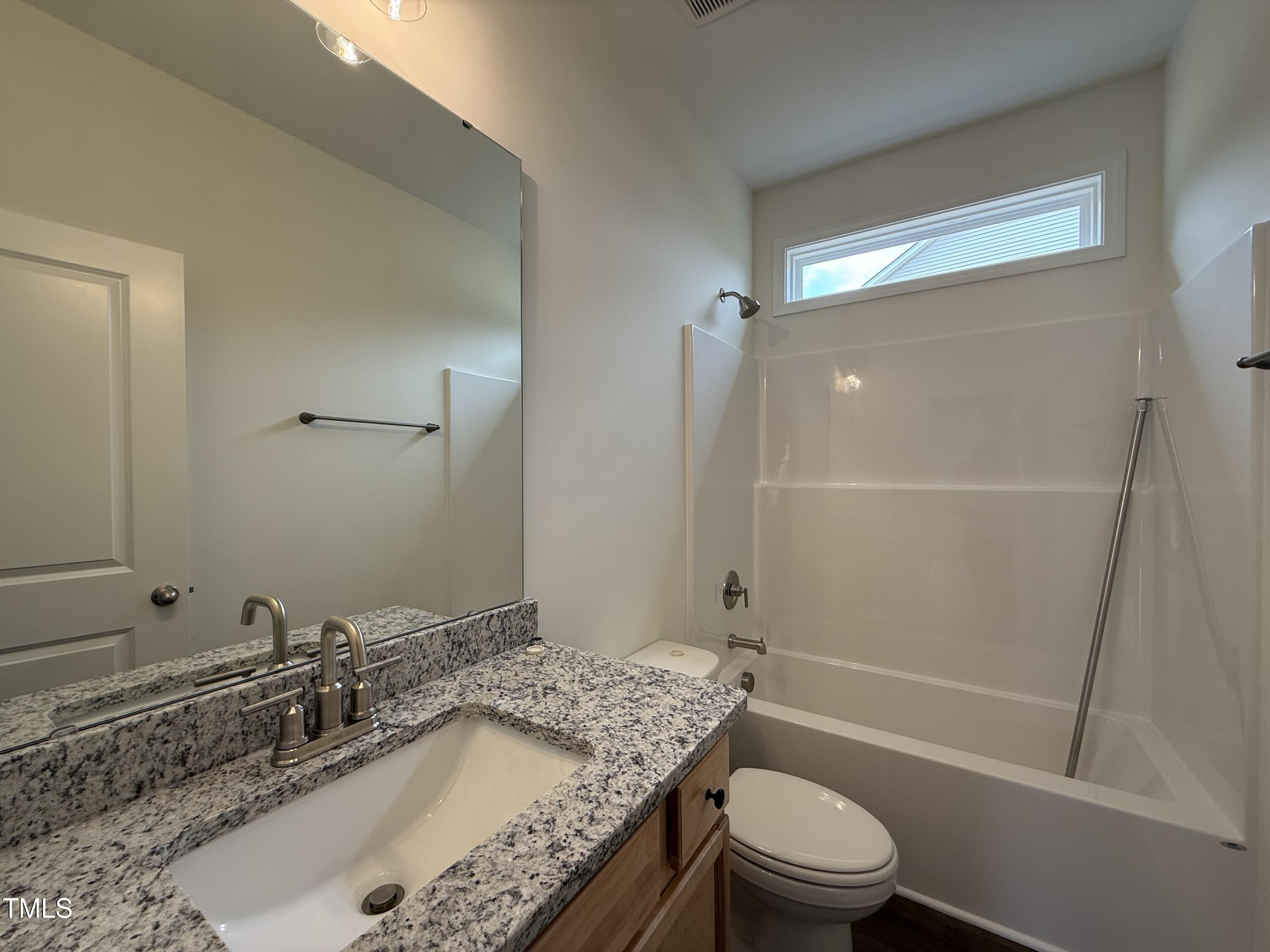 274 Longbow Drive Middlesex, NC 27557 - Photo 12 of 14 a bathroom with a granite countertop sink toilet and shower