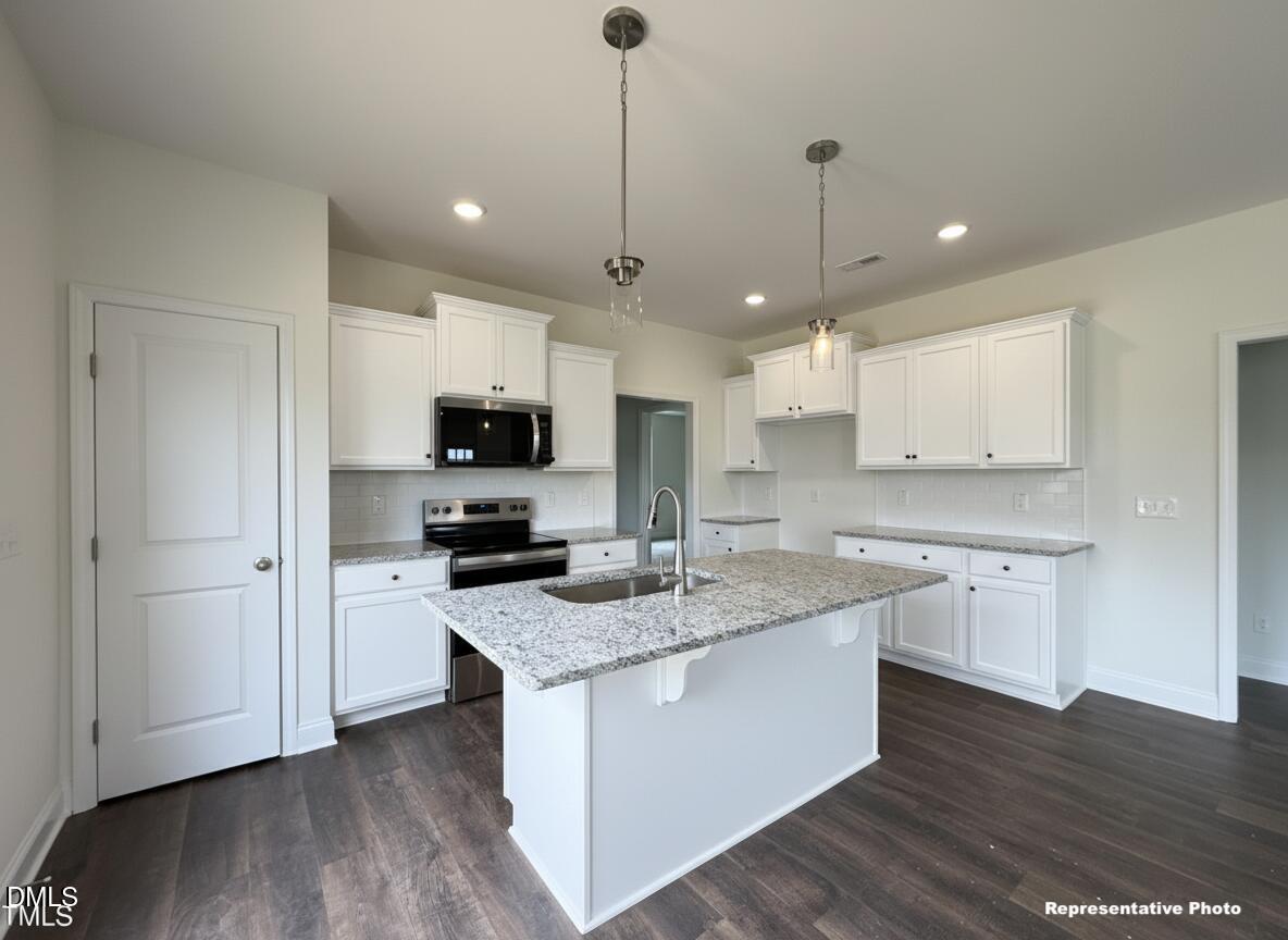 274 Longbow Drive Middlesex, NC 27557 - Photo 2 of 14 a kitchen with granite countertop a sink a counter top space stainless steel appliances and cabinets