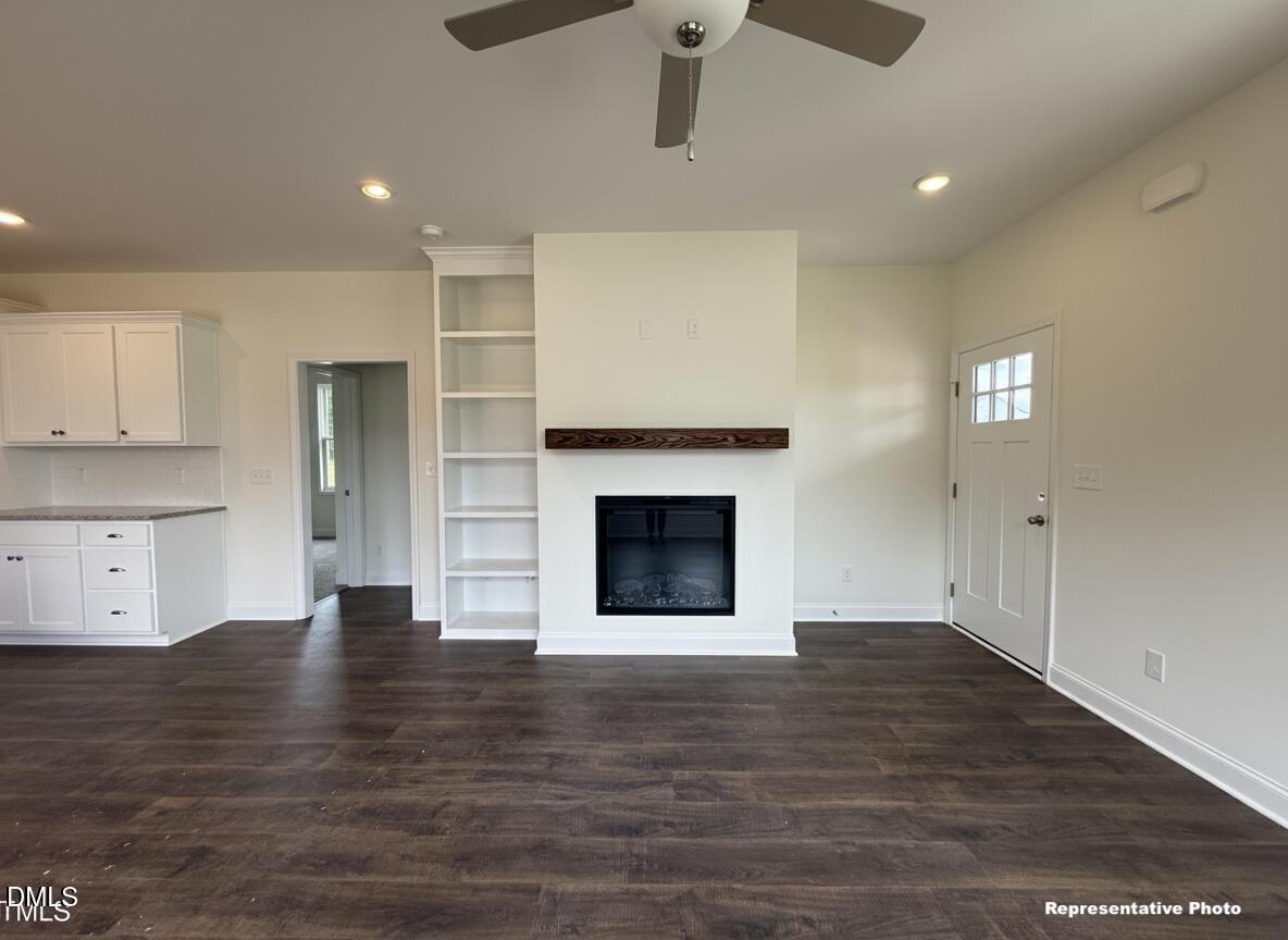 274 Longbow Drive Middlesex, NC 27557 - Photo 7 of 14 a view of an empty room with wooden floor and a fireplace