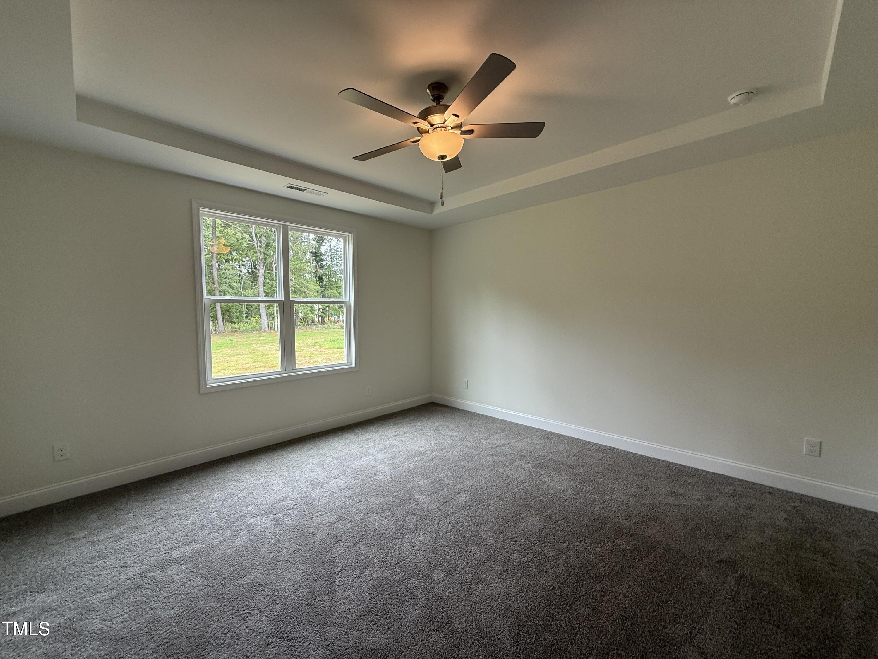 274 Longbow Drive Middlesex, NC 27557 - Photo 8 of 14 an empty room with windows and ceiling fan