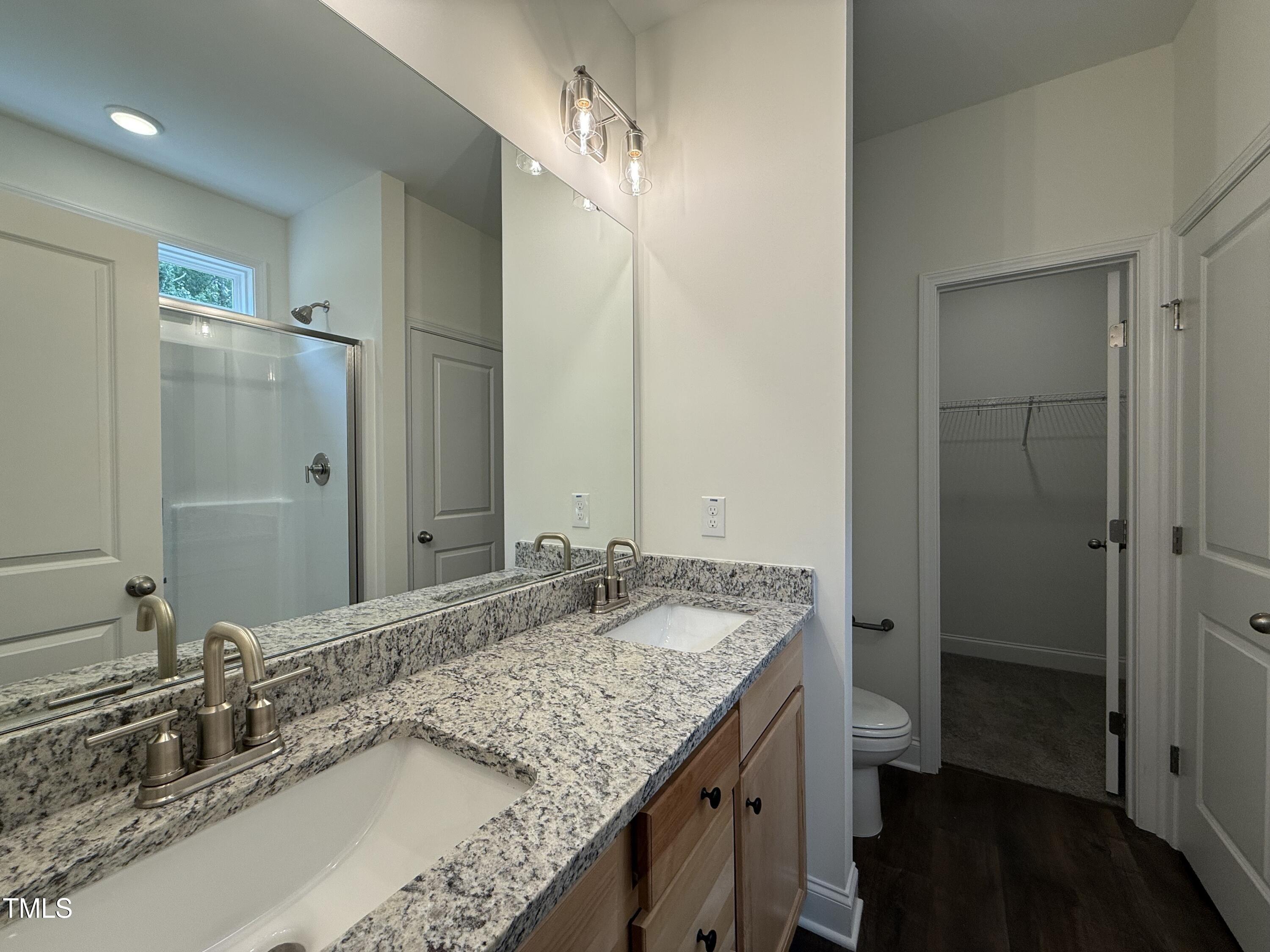 274 Longbow Drive Middlesex, NC 27557 - Photo 9 of 14 a bathroom with a granite countertop double vanity sink and a mirror