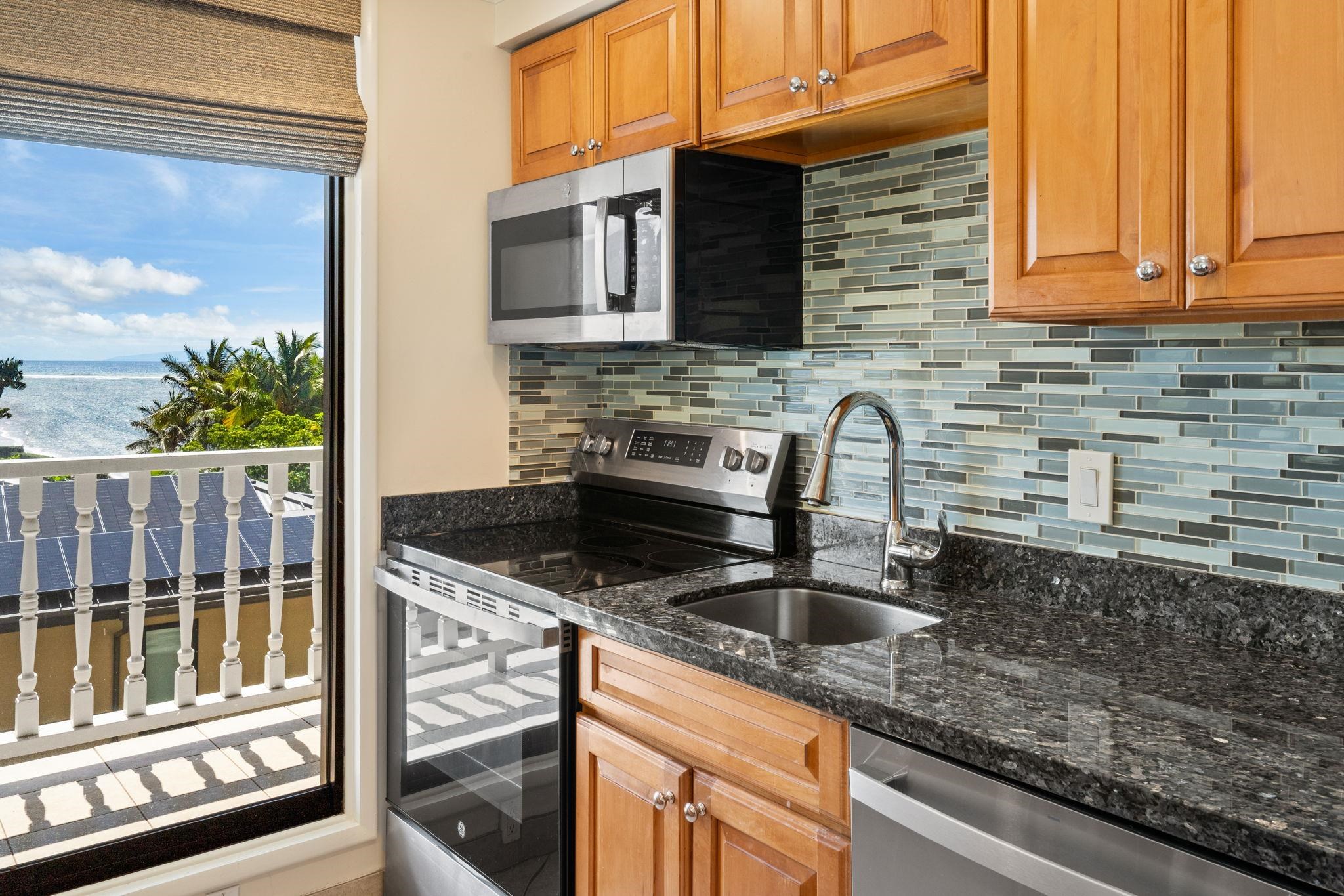 475 Front Street, Unit 402 Lahaina, HI 96761 - Photo 14 of 34 a kitchen with granite countertop a sink and a stove