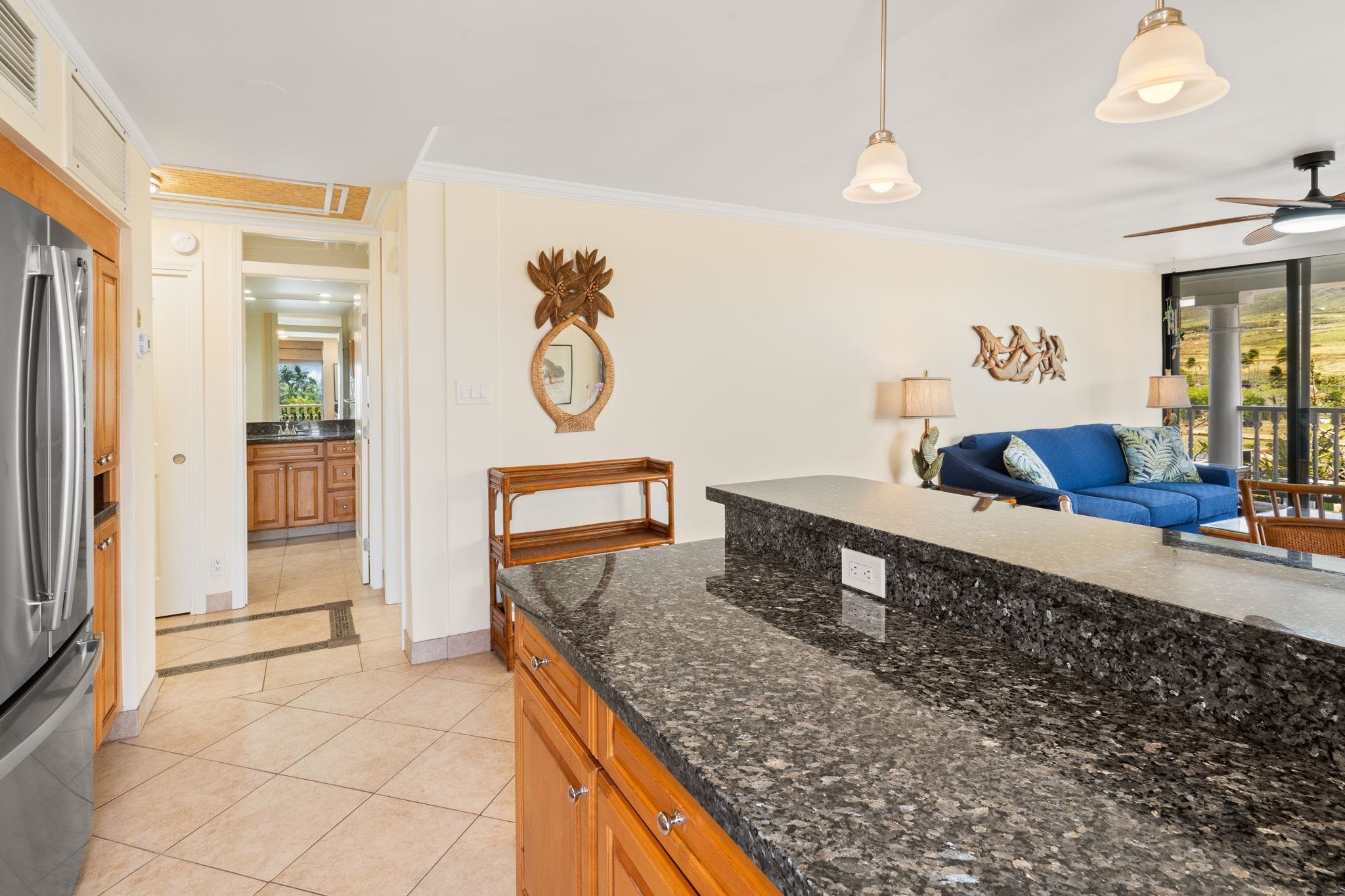 475 Front Street, Unit 402 Lahaina, HI 96761 - Photo 15 of 34 a kitchen with stainless steel appliances granite countertop a sink and a refrigerator
