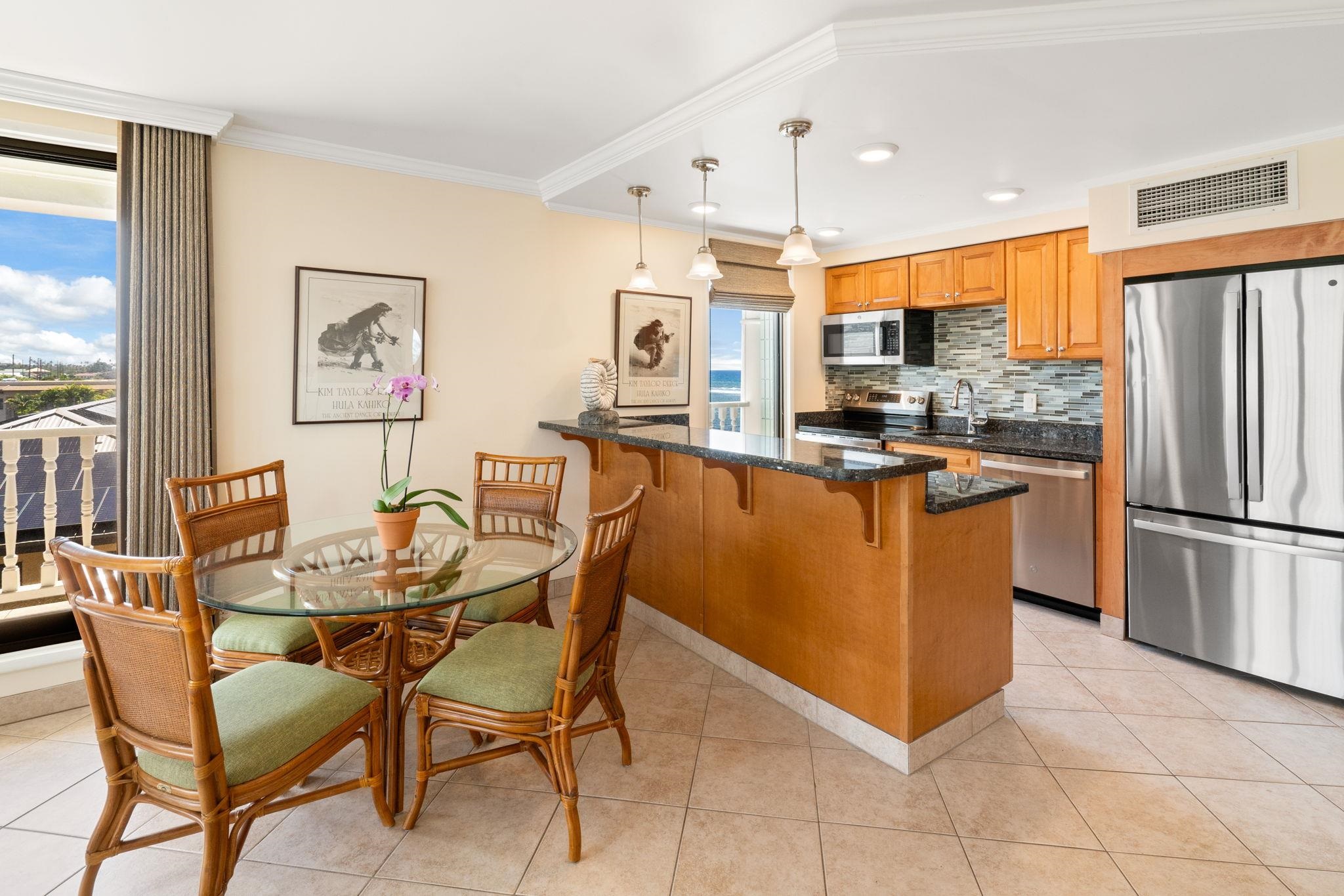 475 Front Street, Unit 402 Lahaina, HI 96761 - Photo 16 of 34 a view of a kitchen with kitchen island stainless steel appliances a table and chairs in it