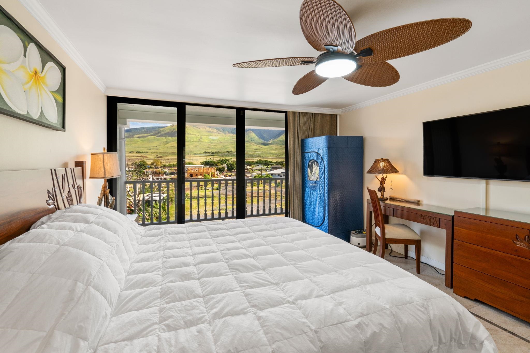 475 Front Street, Unit 402 Lahaina, HI 96761 - Photo 22 of 34 a bedroom with a large bed and a flat screen tv