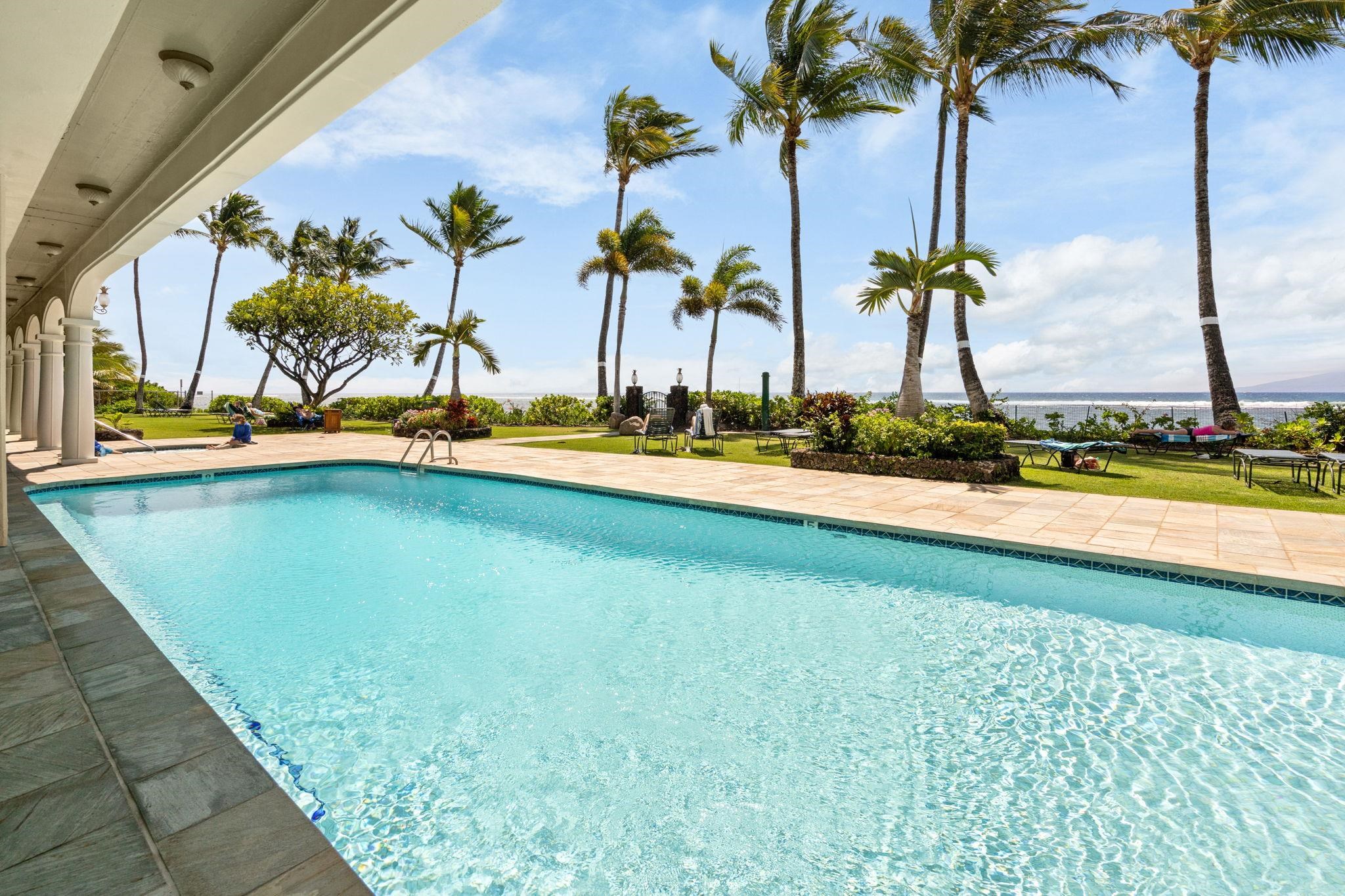 475 Front Street, Unit 402 Lahaina, HI 96761 - Photo 29 of 34 a view of a swimming pool with a yard and palm trees