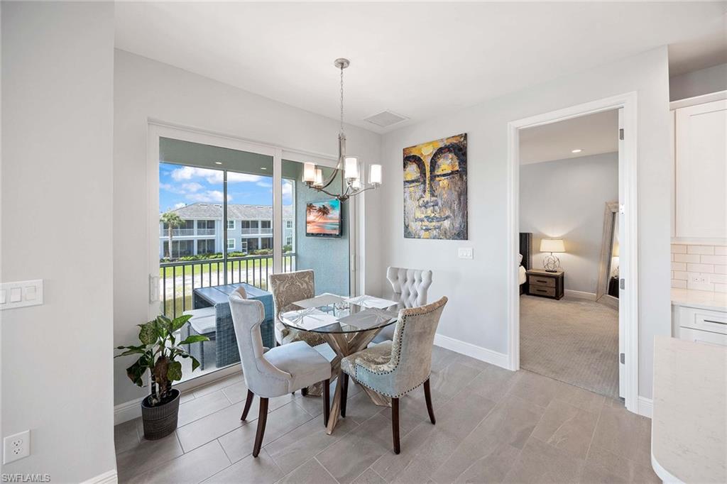 2603 Seychelles Circle, Unit 1505 Naples, FL 34112 - Photo 14 of 35 a view of a dining room that has a table and chairs
