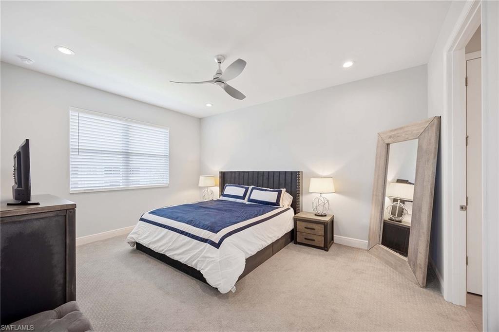 2603 Seychelles Circle, Unit 1505 Naples, FL 34112 - Photo 15 of 35 a bedroom with a bed and a window