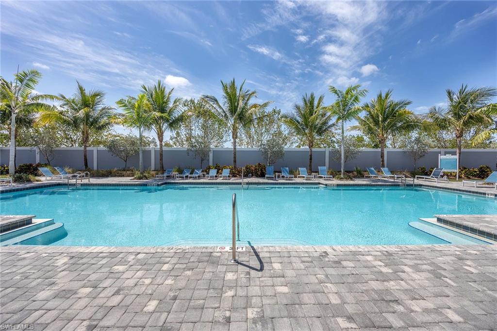 2603 Seychelles Circle, Unit 1505 Naples, FL 34112 - Photo 26 of 35 a view of swimming pool with a yard and palm trees