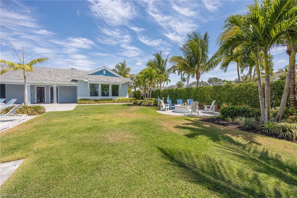 2603 Seychelles Circle, Unit 1505 Naples, FL 34112 - Photo 28 of 35 a swimming pool with outdoor seating and yard
