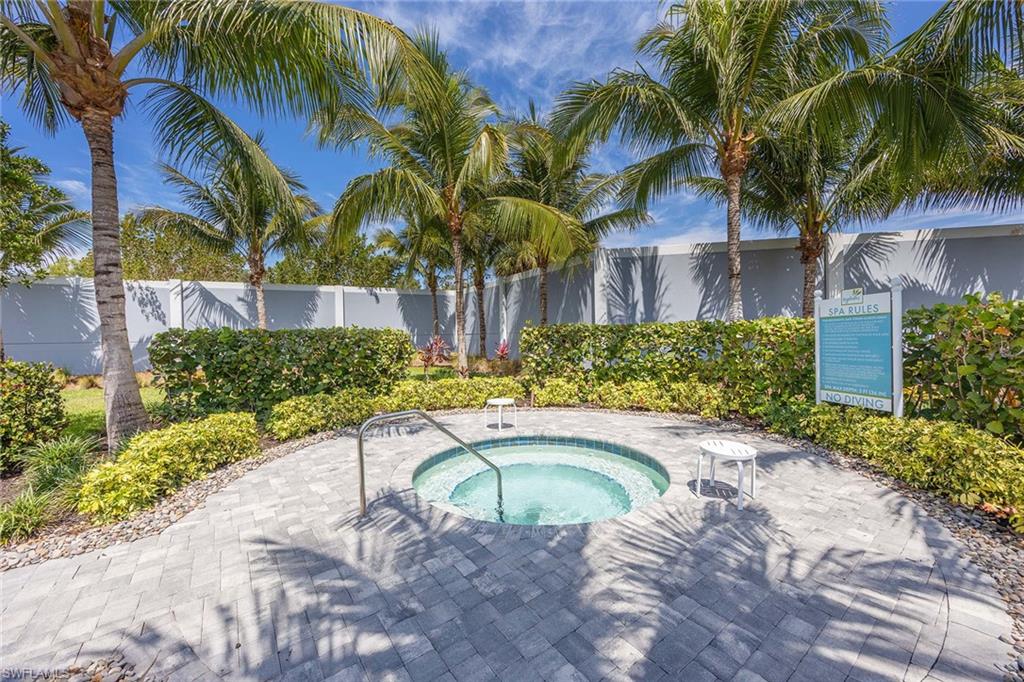 2603 Seychelles Circle, Unit 1505 Naples, FL 34112 - Photo 29 of 35 a view of a swimming pool with a garden