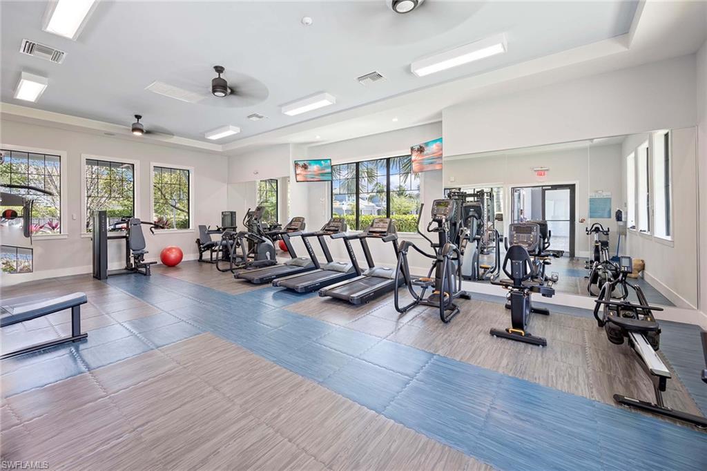 2603 Seychelles Circle, Unit 1505 Naples, FL 34112 - Photo 33 of 35 a view of a livingroom with hardwood floor and a gym cycle