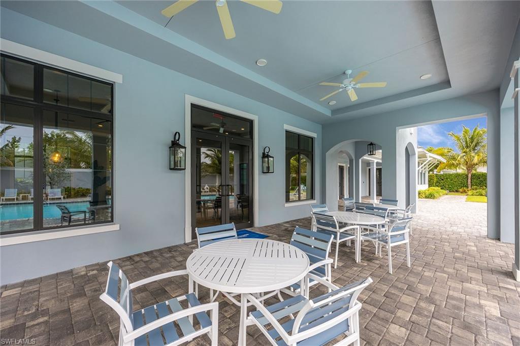 2603 Seychelles Circle, Unit 1505 Naples, FL 34112 - Photo 34 of 35 a dining room with furniture a rug and chandelier
