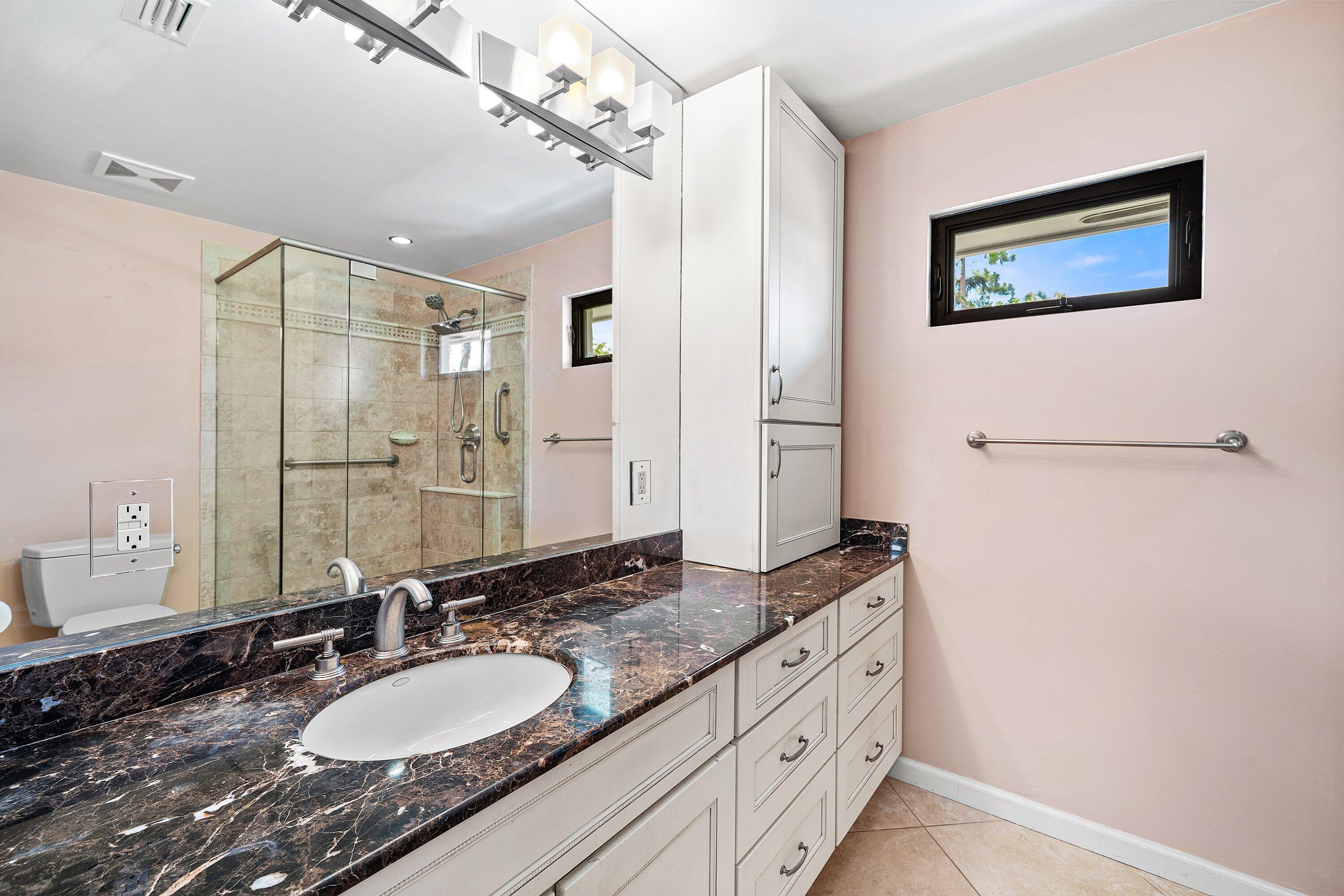 4365 Shell Drake Lane Boynton Beach, FL 33436 - Photo 23 of 56 a bathroom with a granite countertop double vanity sink a mirror and shower