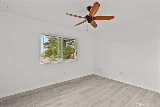 a view of a room with a window and a ceiling fan