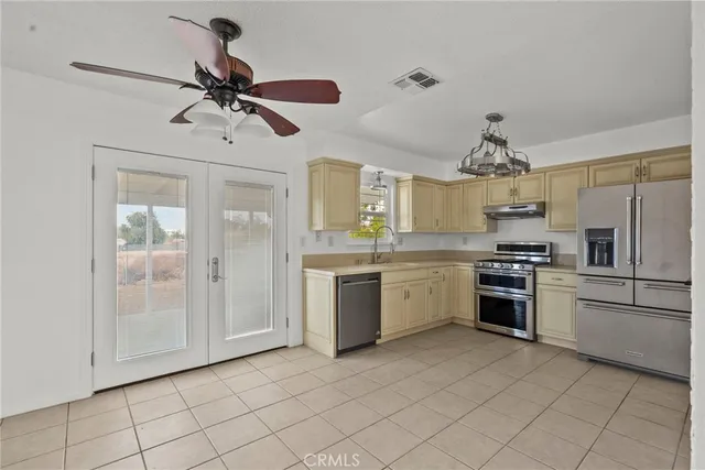 a kitchen with a refrigerator sink and cabinets