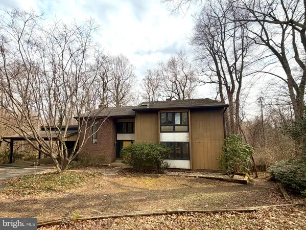 a house that has a tree in front of it