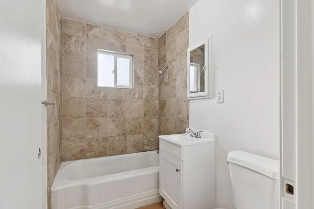 a bathroom with a bathtub sink and toilet