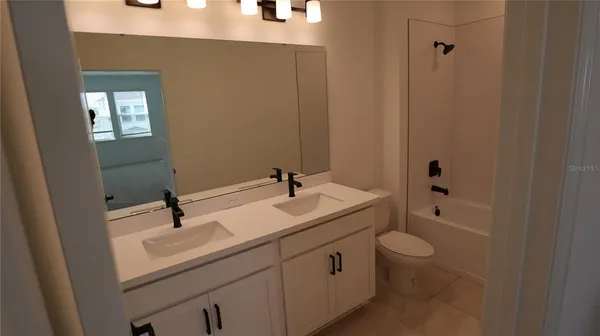 a bathroom with a sink toilet a mirror and shower