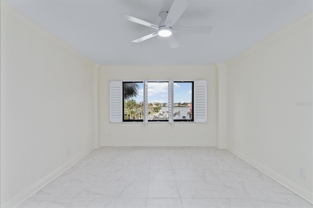 5911 Midnight Pass Road, Unit 206 Sarasota, FL 34242 - Photo 32 of 88 an empty room with windows and ceiling fan