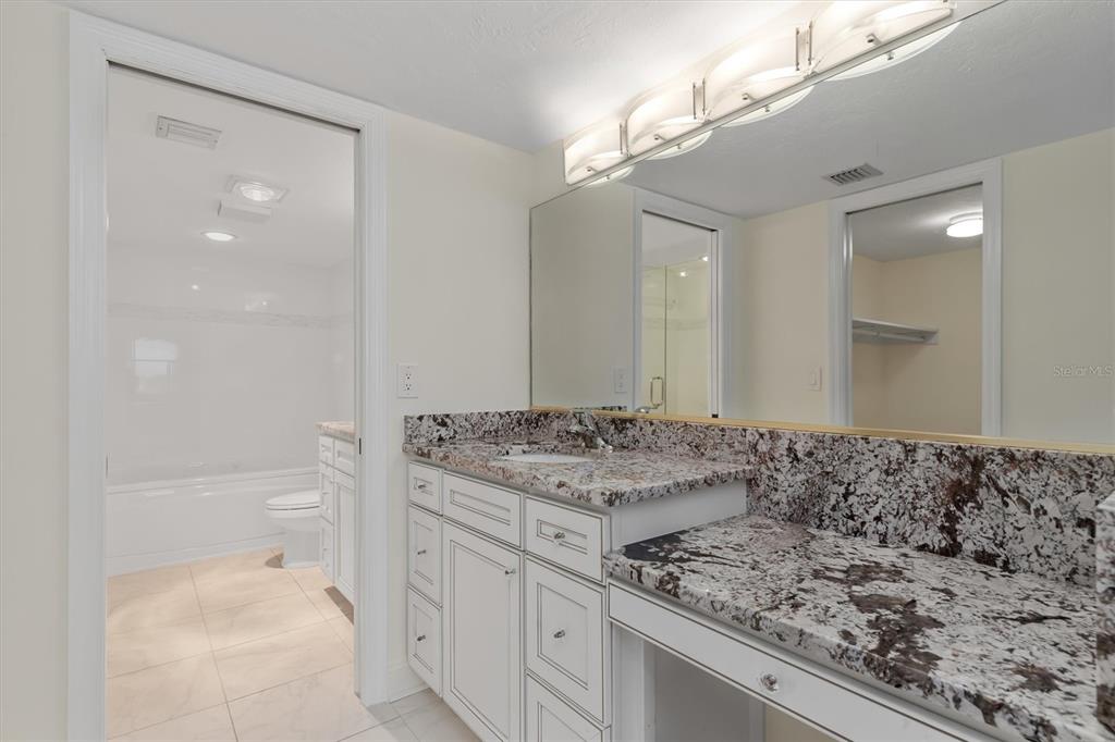 5911 Midnight Pass Road, Unit 206 Sarasota, FL 34242 - Photo 34 of 88 a bathroom with a sink vanity granite and toilet
