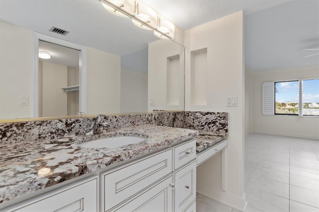 5911 Midnight Pass Road, Unit 206 Sarasota, FL 34242 - Photo 35 of 88 a bathroom with a sink and a mirror