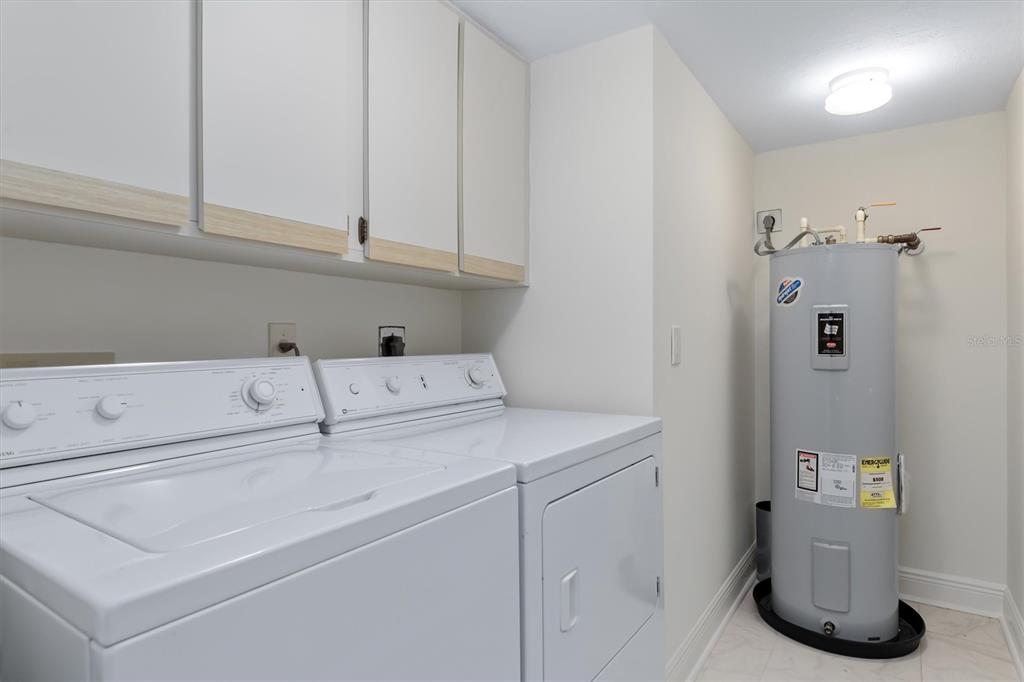 5911 Midnight Pass Road, Unit 206 Sarasota, FL 34242 - Photo 44 of 88 a utility room with dryer and washer
