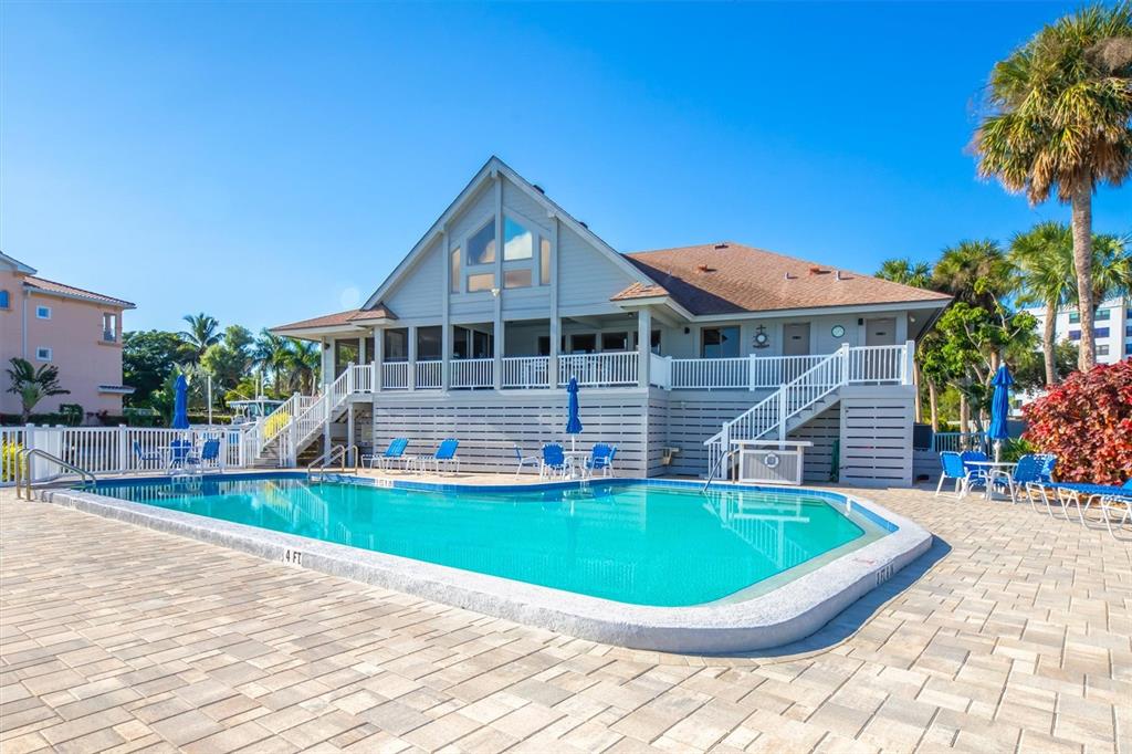 5911 Midnight Pass Road, Unit 206 Sarasota, FL 34242 - Photo 51 of 88 a view of a house with a swimming pool and a chairs