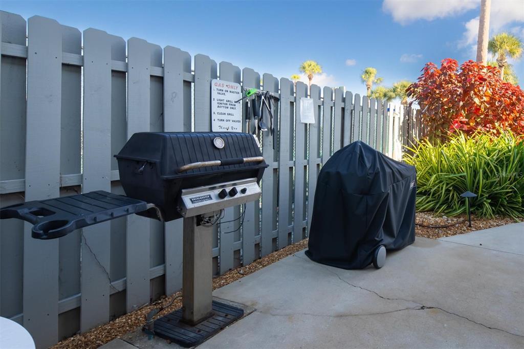 5911 Midnight Pass Road, Unit 206 Sarasota, FL 34242 - Photo 60 of 88 a view of a wooden door with a bench and a grill