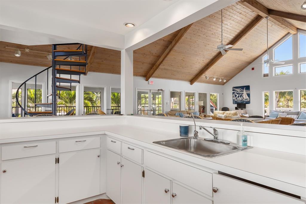 5911 Midnight Pass Road, Unit 206 Sarasota, FL 34242 - Photo 64 of 88 a kitchen with stainless steel appliances sink and cabinets