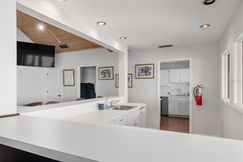 5911 Midnight Pass Road, Unit 206 Sarasota, FL 34242 - Photo 65 of 88 a living room with furniture and a flat screen tv