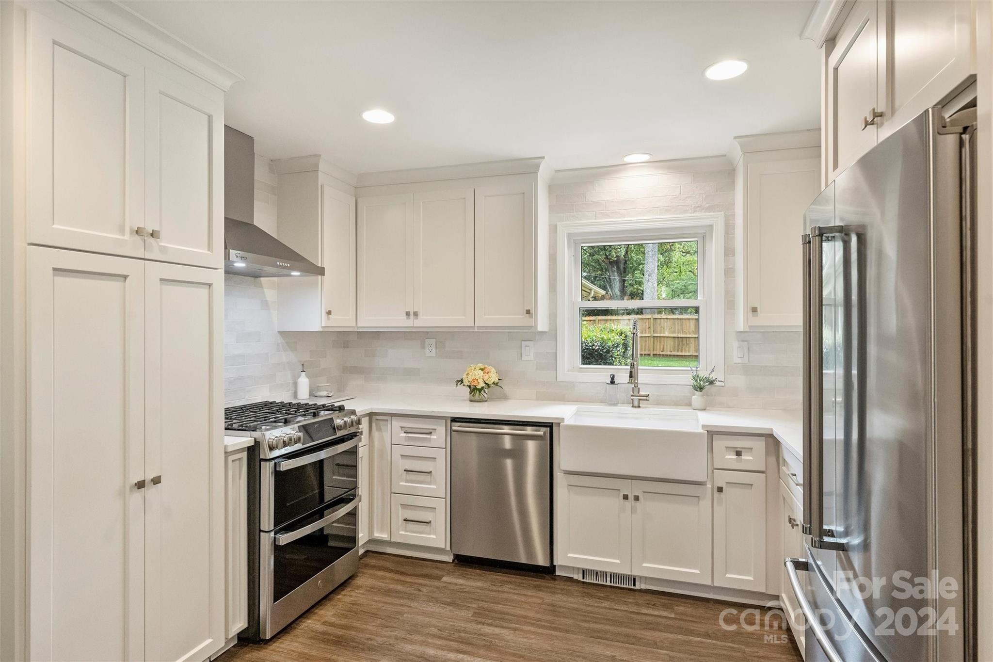 5501 Seacroft Road Charlotte, NC 28210 - Photo 11 of 37 a kitchen with stainless steel appliances a stove a sink and a refrigerator